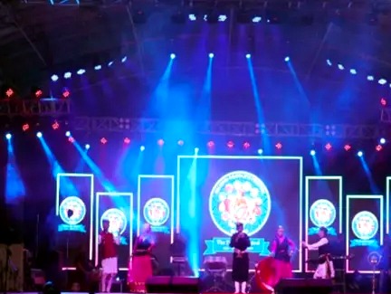 Kalamanch stage with blue moving lights and live performers