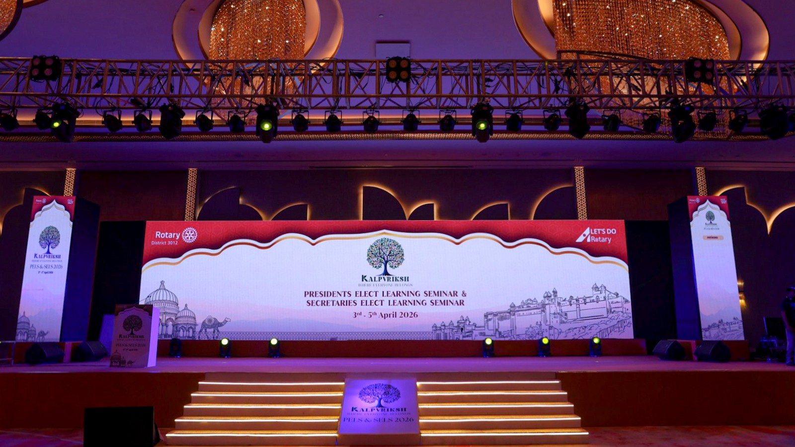 Conference stage with LED screen, illuminated steps and overhead lighting truss